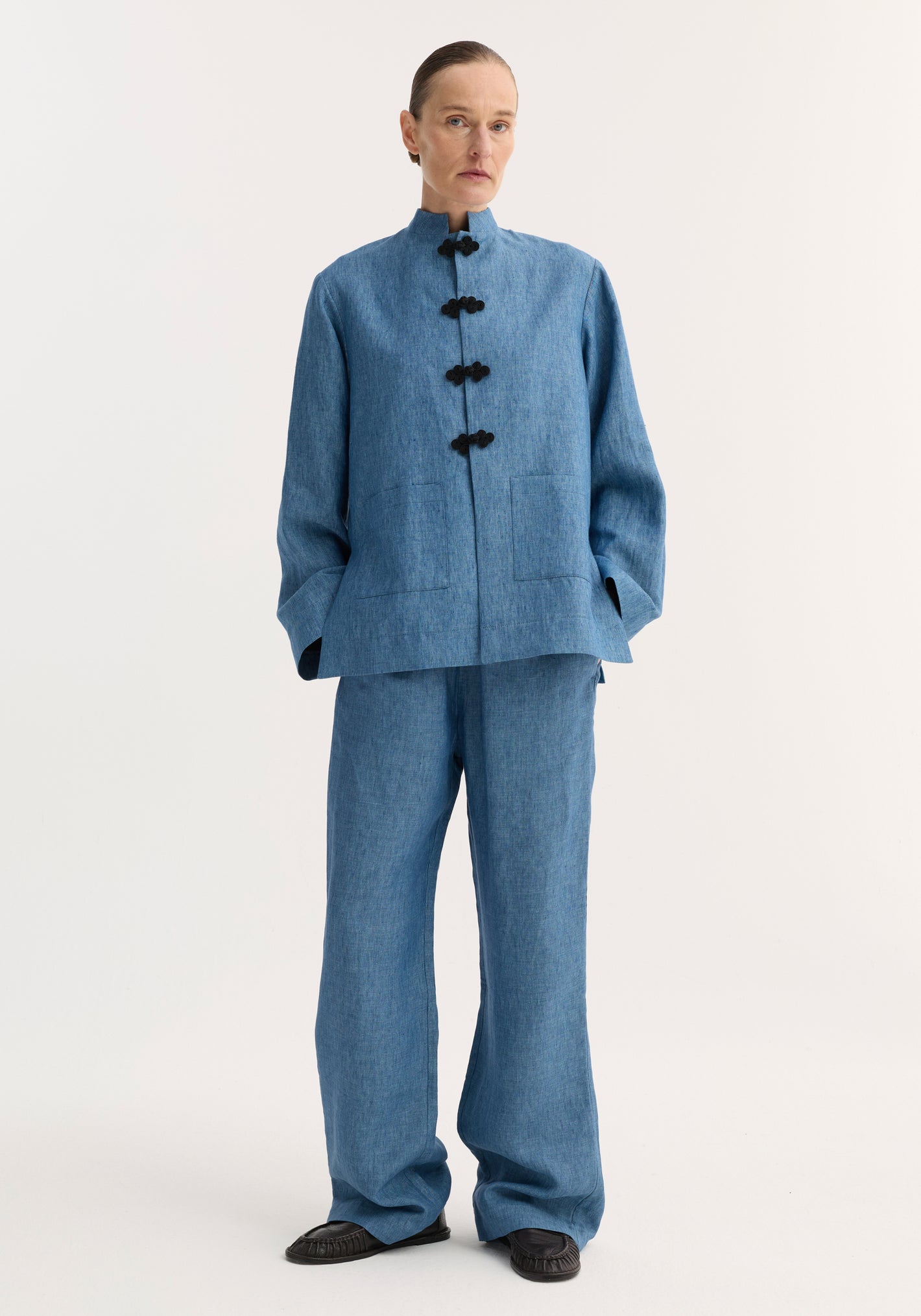 Mandarin jacket | ocean blue: A minimalist, androgynous two-piece with a linen jacket featuring black pankou closures and patch pockets, paired with relaxed wide-leg pants.