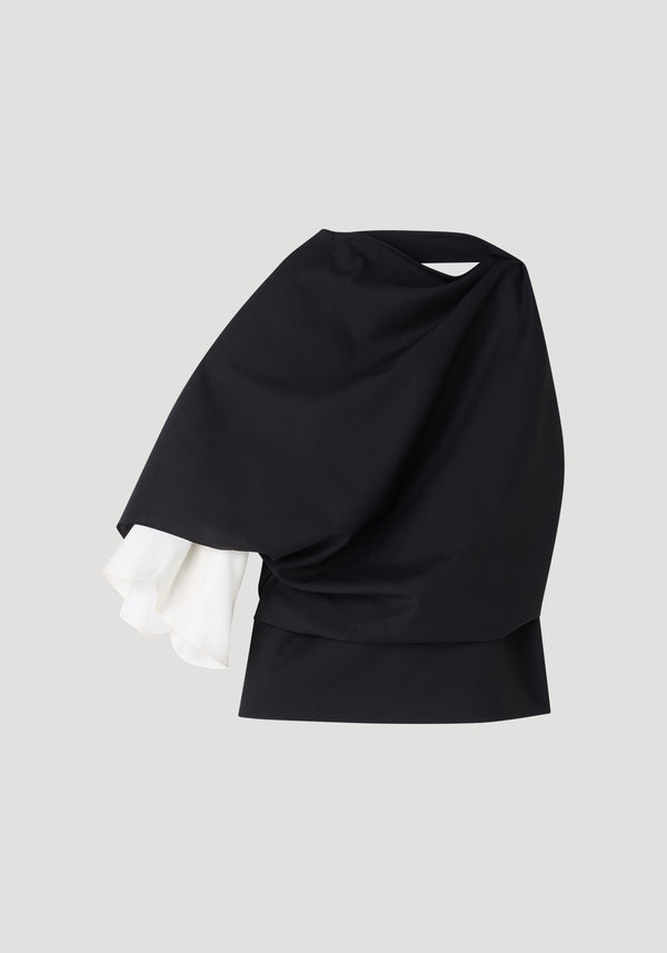 Draped open back wool top featuring an asymmetrical, one-shoulder design with a single white ruffled sleeve and refined wrap construction. Model wears size 36.