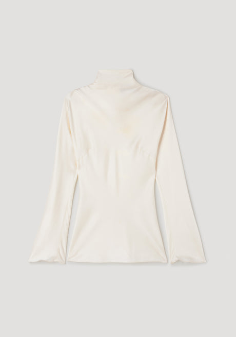 Person wearing Satin waisted top | cream in a sleek, long-sleeve design with a high neckline paired with black slim trousers and black strappy heels against a plain background.