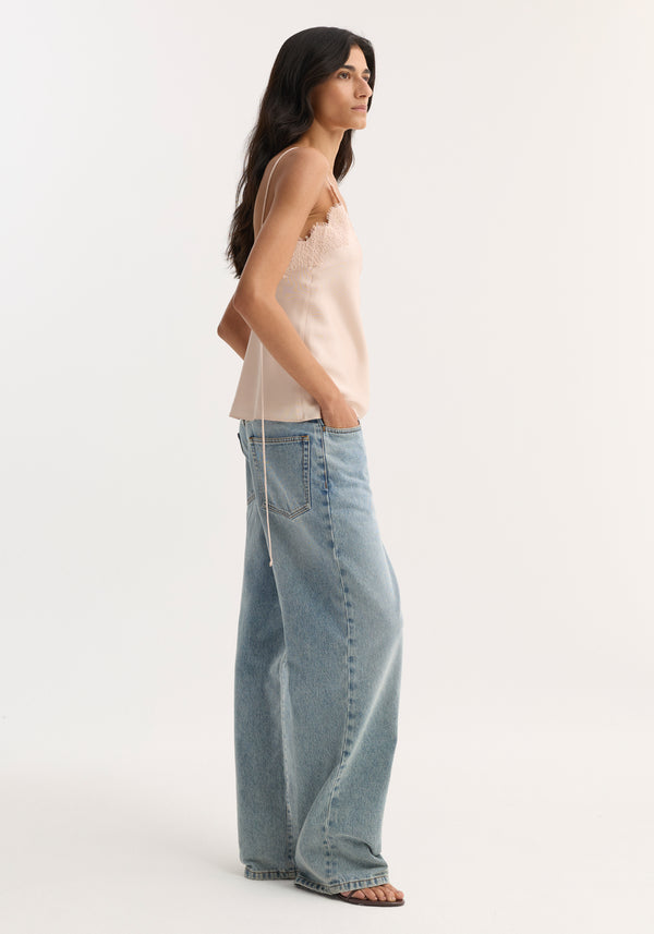 Model in Lace Silk Camisole | Rose, featuring V-neck, lace trim, adjustable straps; paired with high-waisted wide-leg jeans and flat sandals.