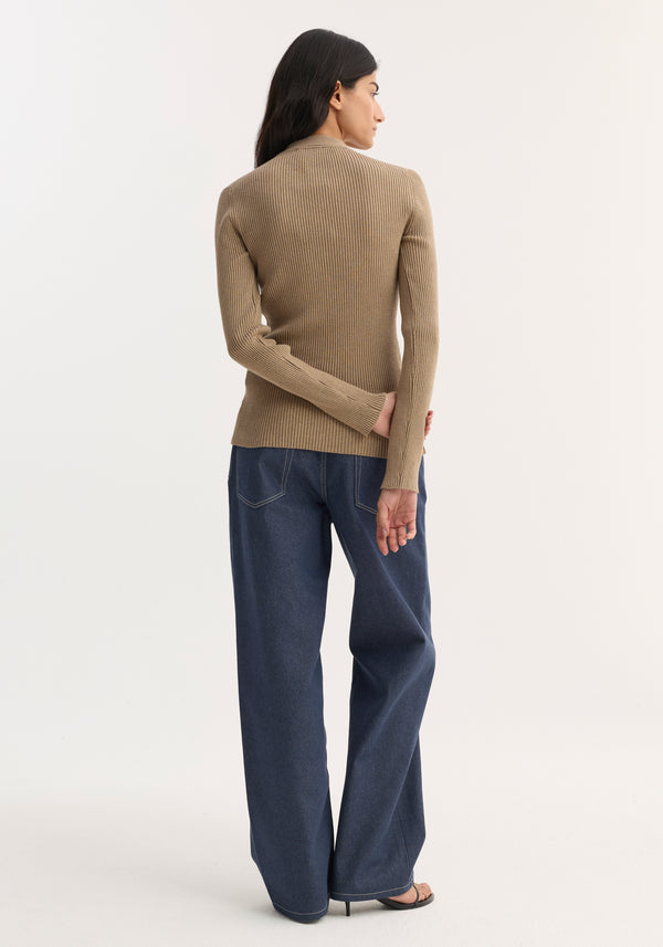 Person wearing a taupe melange elongated rib cardigan, featuring a collar and button closures, paired with indigo wide-leg jeans and black stiletto sandals.