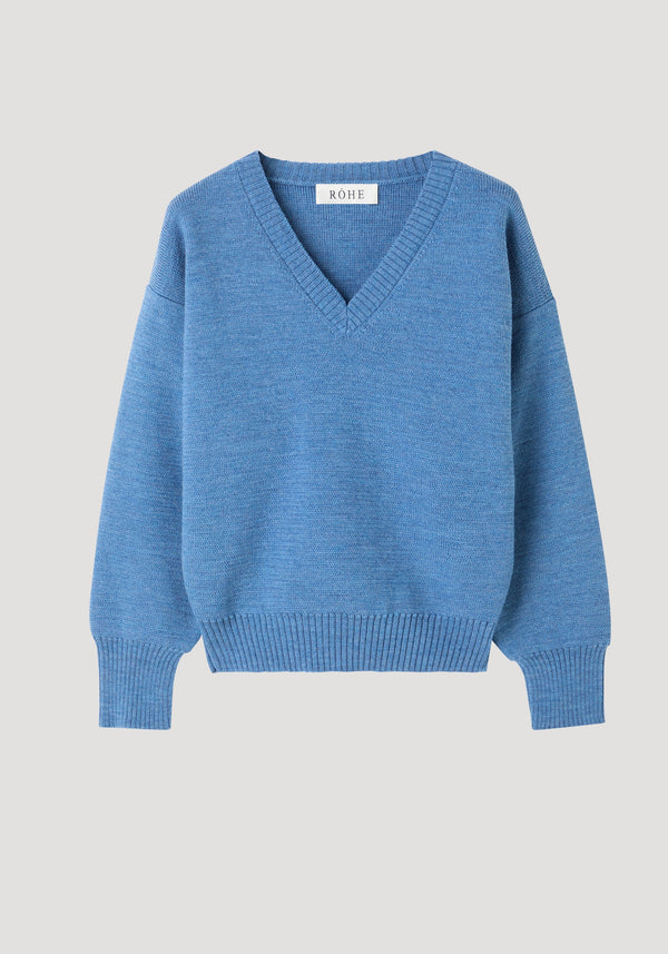 V-neck knitted jumper in denim blue melange, featuring a relaxed fit, V-neckline, ribbed cuffs, hem, and dropped shoulders with a RÓHE label at the back.