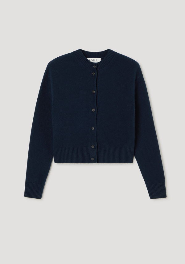 Short boiled cardigan | navy: A cropped knit cardigan with a high crew neck, drop shoulders, ribbed cuffs, and dark buttons, showcasing a felted wool texture.