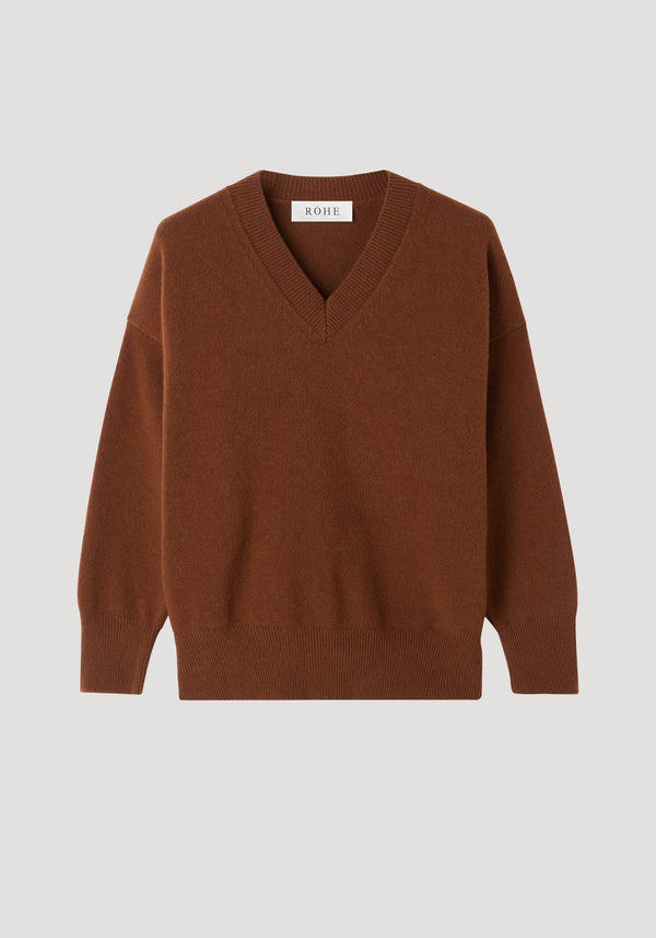 V-neck knitted jumper | rust with relaxed fit, dropped shoulders, and ribbed trims. Features a V-neck collar, finely ribbed edges, and a RÓHE brand tag.