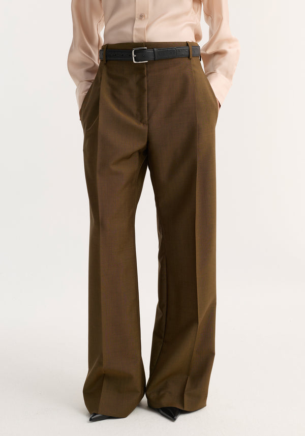 A model wears Relaxed straight leg trouser | golden brown with sharp front pleats, belted waist, and pointed-toe black shoes.