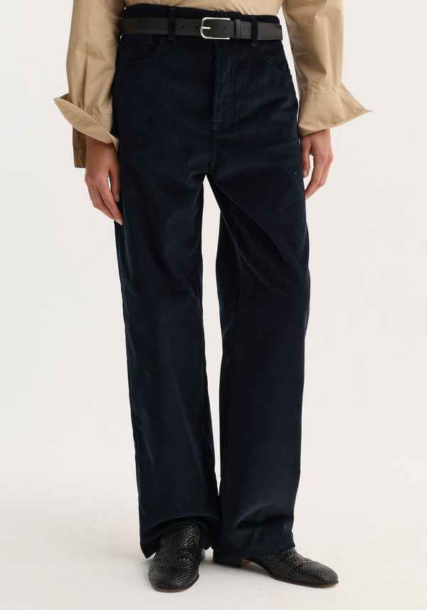 Relaxed corduroy trousers | night: High-waisted, wide-leg navy corduroy trousers with denim-inspired detailing, paired with a black belt and black woven leather slip-ons.