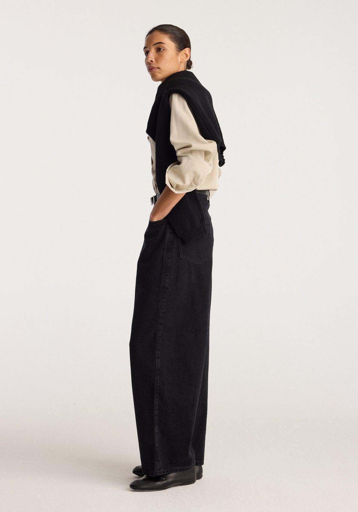 Berber - Barrel leg denim | black worn by a model in side profile with a relaxed barrel leg and full length black denim design