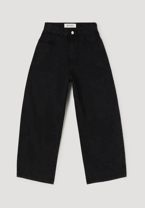 Barrel leg denim | black, featuring high-waisted, wide-leg design in raw cotton with a curved, slightly cropped silhouette and branded RÓHE button detail.