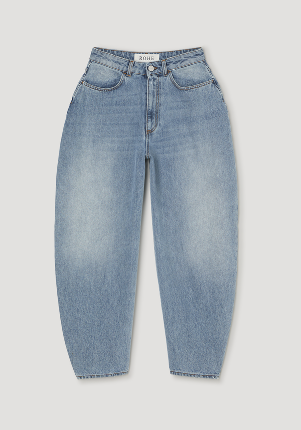 Sculptural denim trousers in classic blue, featuring a high waist, balloon leg, and tapered cut, laid flat showcasing five-pocket design and RÓHE label.