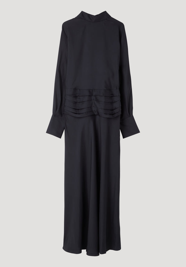 Tuxedo silk dress in black, featuring a high neckline, flowing sleeves, open back to waist, cummerbund detailing, tiered ruffles, and side zip.