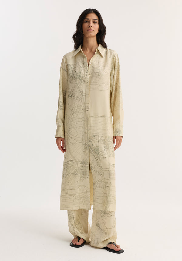 Model wearing Silk open back wrap dress | Amsterdam, featuring a button-down front, map-like print, keyhole back with wrap tie, paired with matching trousers.