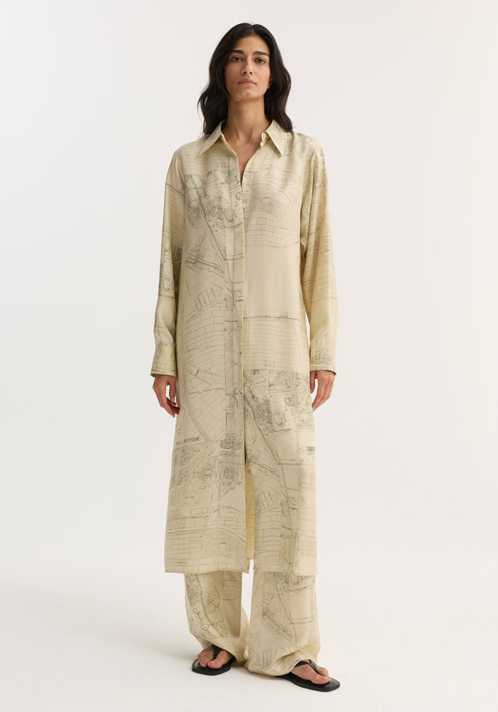 Model wearing Silk open back wrap dress | Amsterdam, featuring a button-down front, map-like print, keyhole back with wrap tie, paired with matching trousers.