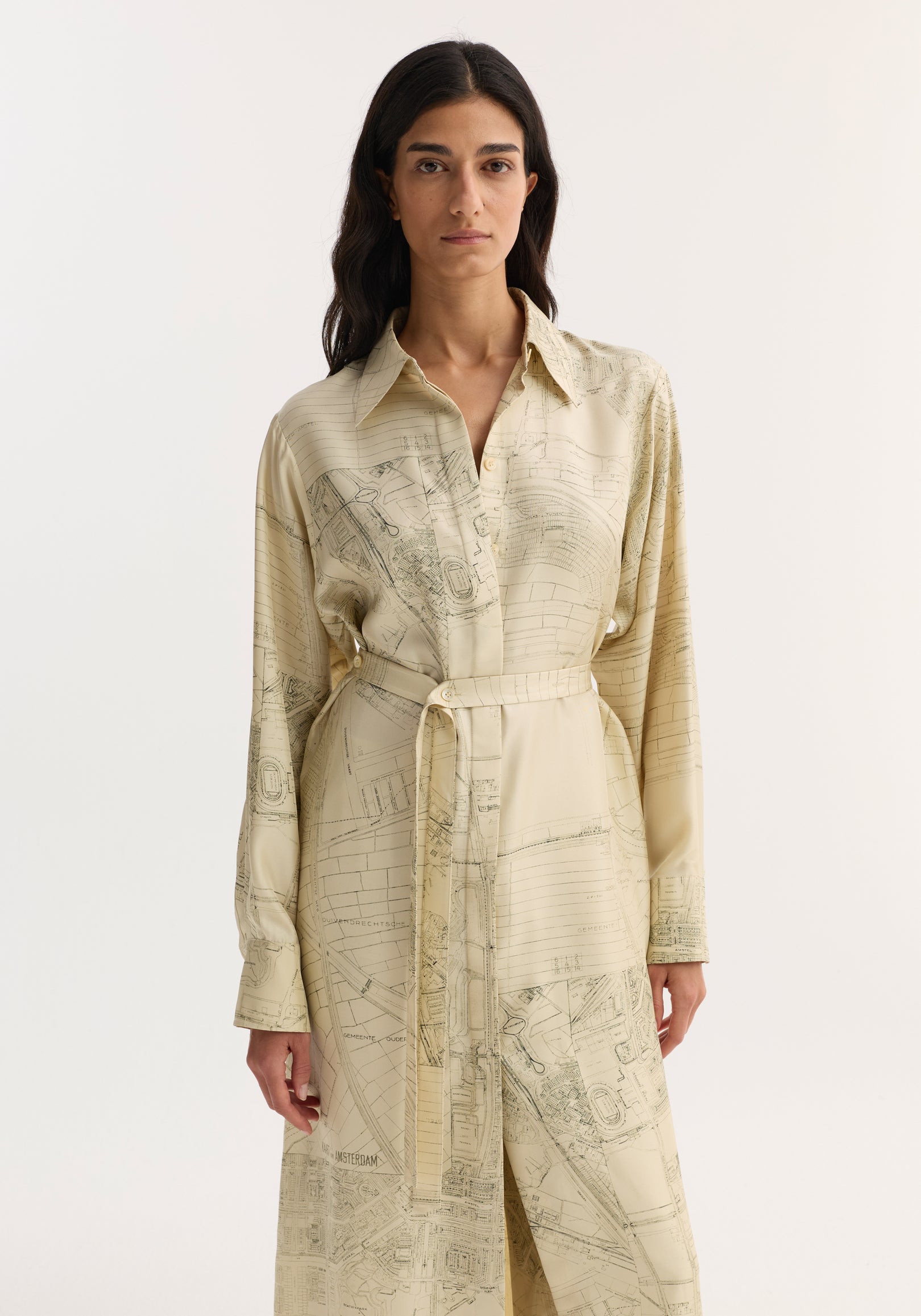 A model wears the Silk open back wrap dress | Amsterdam, featuring map prints, a belted waist, long sleeves, and a keyhole back with wrap tie.