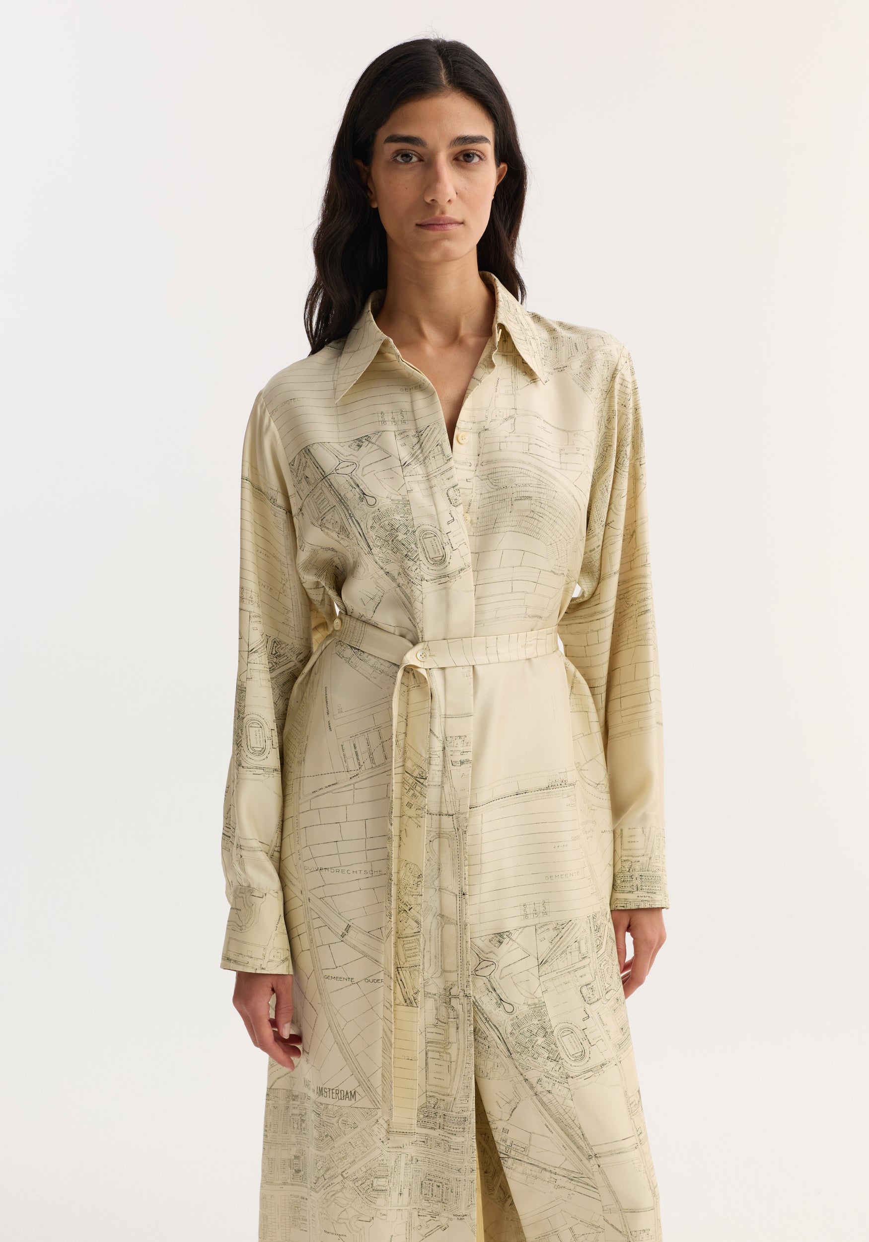 A model wears the Silk open back wrap dress | Amsterdam, featuring map prints, a belted waist, long sleeves, and a keyhole back with wrap tie.