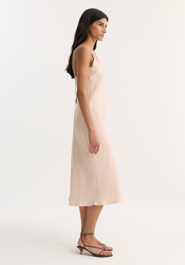 Lace slip dress | rose: A blush silk midi slip dress with lace neckline and adjustable spaghetti straps, worn with dark strappy heeled sandals.