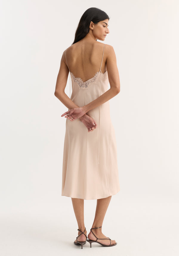 Lace slip dress | rose shown on model, featuring a midi-length silk slip with slim spaghetti straps and scalloped lace trim on the low back.