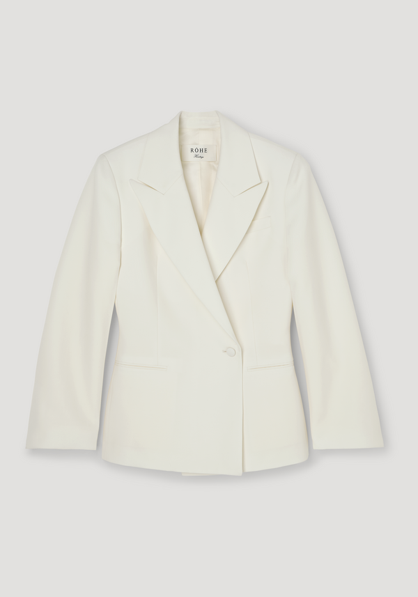 Hourglass-shaped blazer in off-white, featuring a sharp notch lapel, cinched waist, single button closure, and welt pockets. Made from 100% virgin wool.