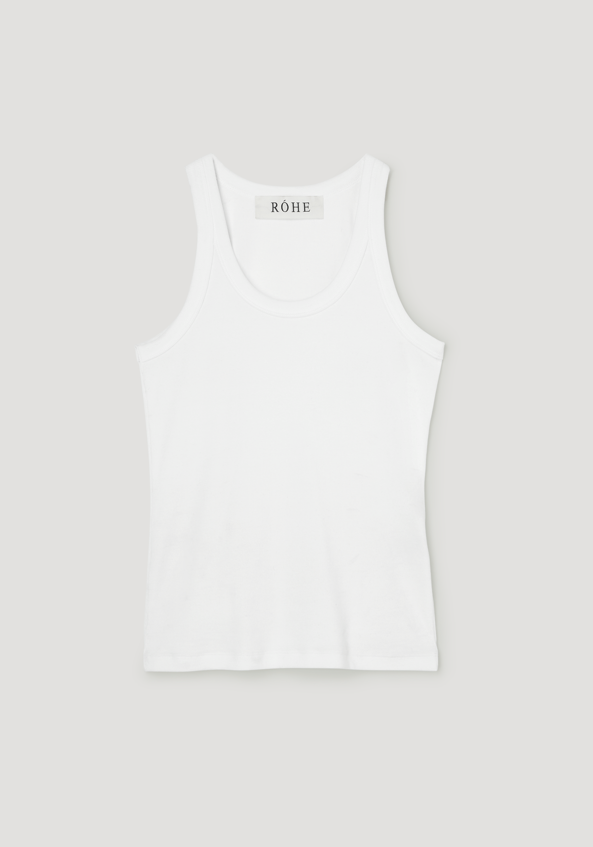 Scoop-neck rib top in optic white, featuring a racerback with narrow straps, and a label reading RÓHE at the back. Made from organic cotton blend.