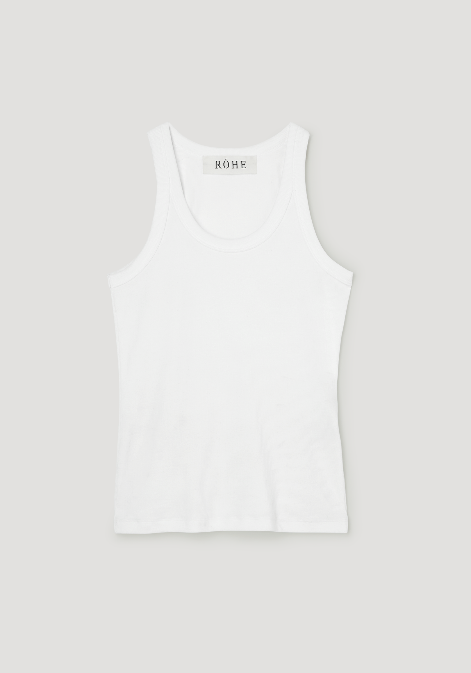 Scoop-neck rib top in optic white, featuring a racerback with narrow straps, and a label reading RÓHE at the back. Made from organic cotton blend.