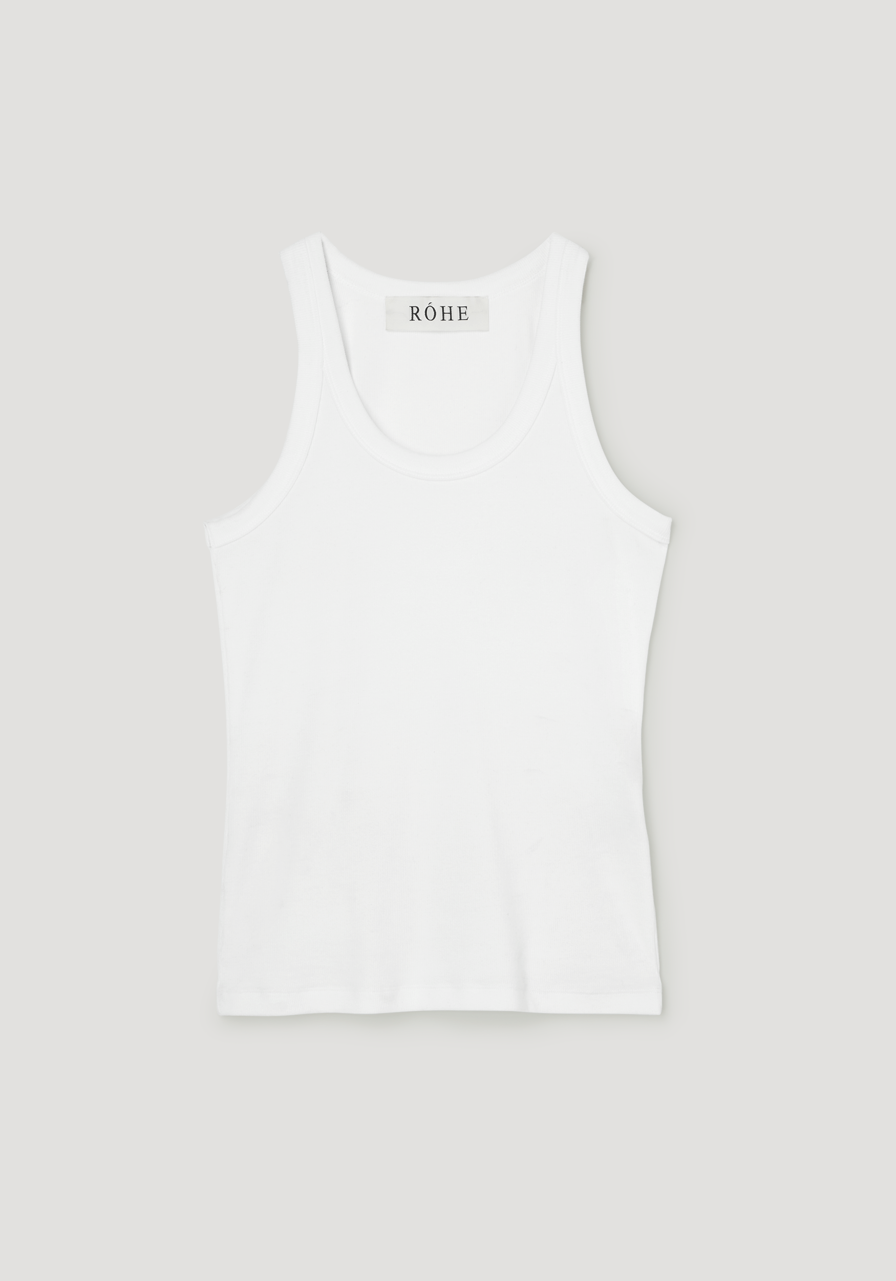 Scoop-neck rib top in optic white, featuring a racerback with narrow straps, and a label reading RÓHE at the back. Made from organic cotton blend.