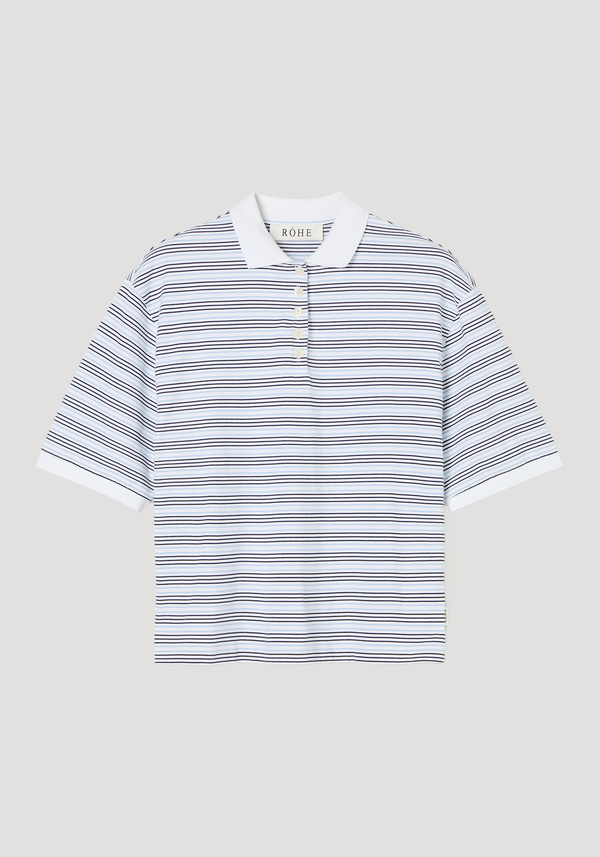 Striped oversized polo with white and light blue stripes, white ribbed collar, and four-button placket. Features an oversized fit, crafted from 100% cotton.
