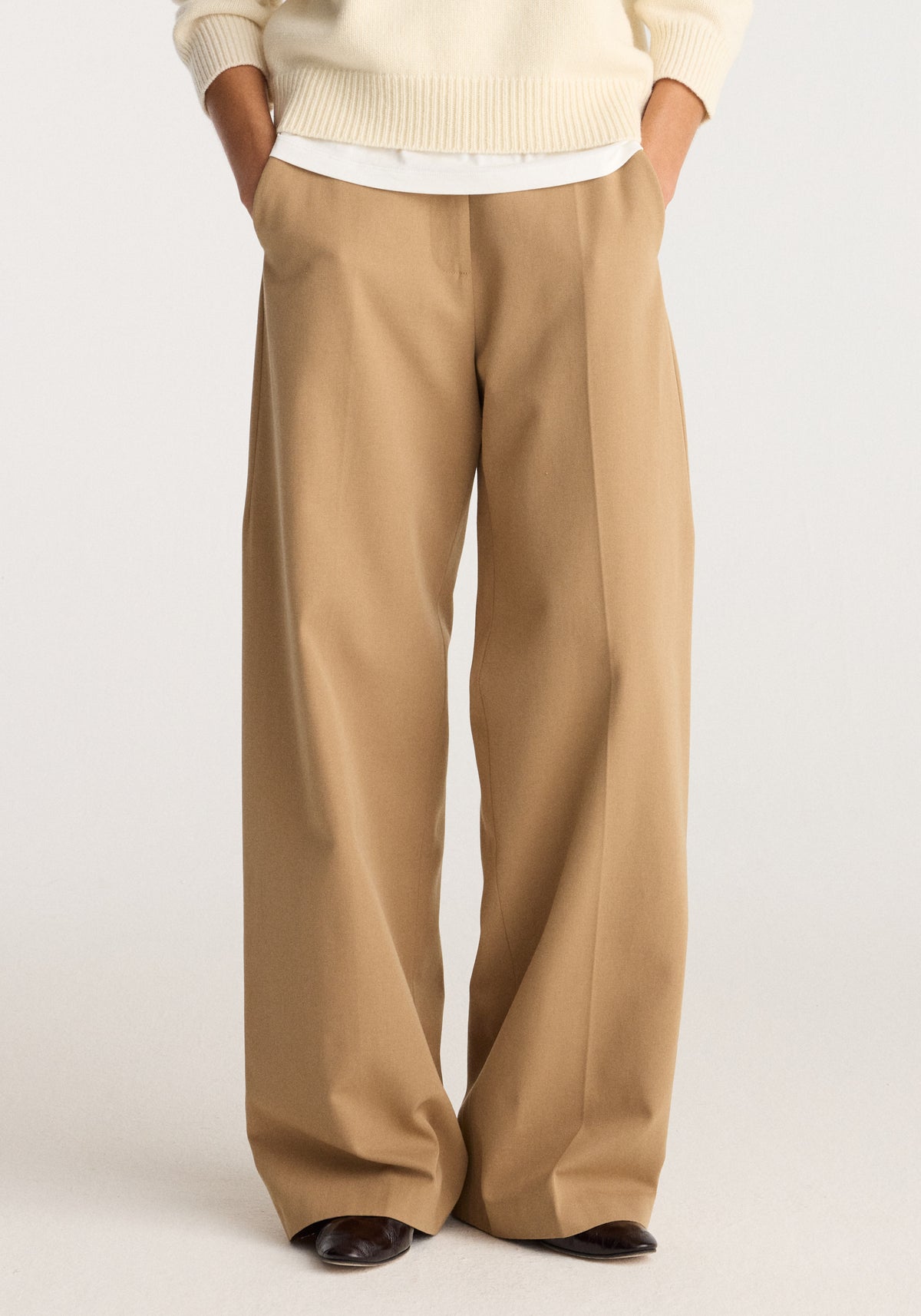 Classic loose fit chino | beige shown on a model with a relaxed fit, straight wide legs, front pockets, and polished dark shoes