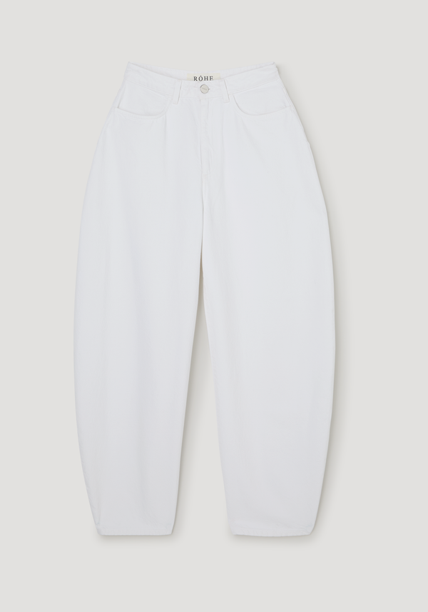 Sculptural denim trousers in optic white, featuring a high waist, balloon legs, and RÓHE label at the waistband, showcasing a modern, relaxed fit.