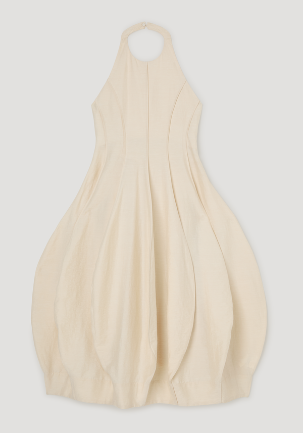 Open back tulip dress | butter, featuring a fitted halter-neck bodice with princess seams, bubble-style skirt, and button closure, highlighting its elegant, sculptural silhouette.