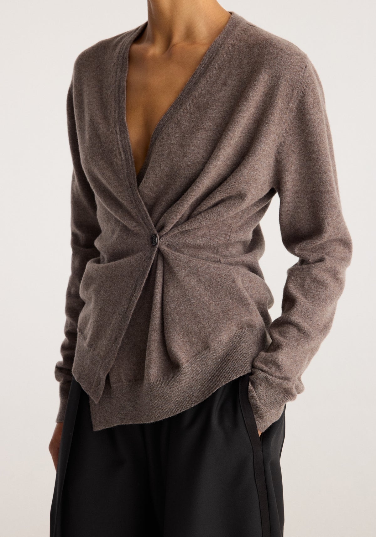 Twisted ballet cardigan | mud in a soft brown knit with a wrap front, twisted waist detail, long sleeves, and a flattering fitted silhouette over black trousers