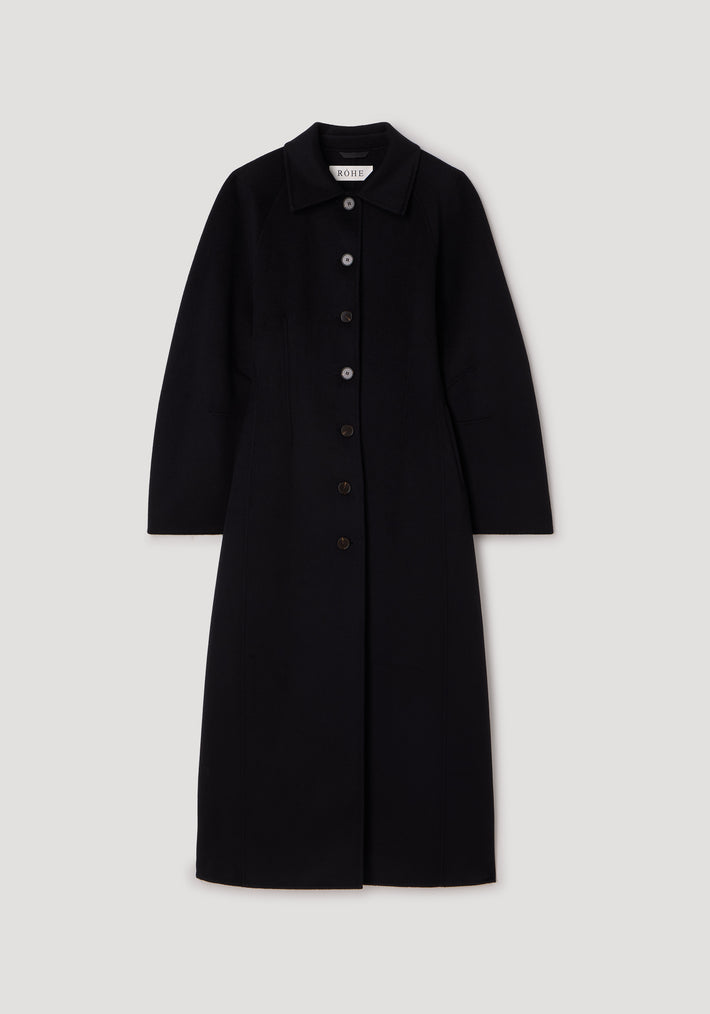 Black long coat with a button-down front and collar, featuring a tailored silhouette and clean lines, styled as the Double-faced elongated sculptural coat | black.