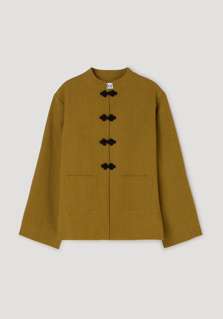 Pankou closure jacket | mustard featuring a straight cut, long sleeves, two front pockets, and traditional black pankou knot buttons on a stand collar.