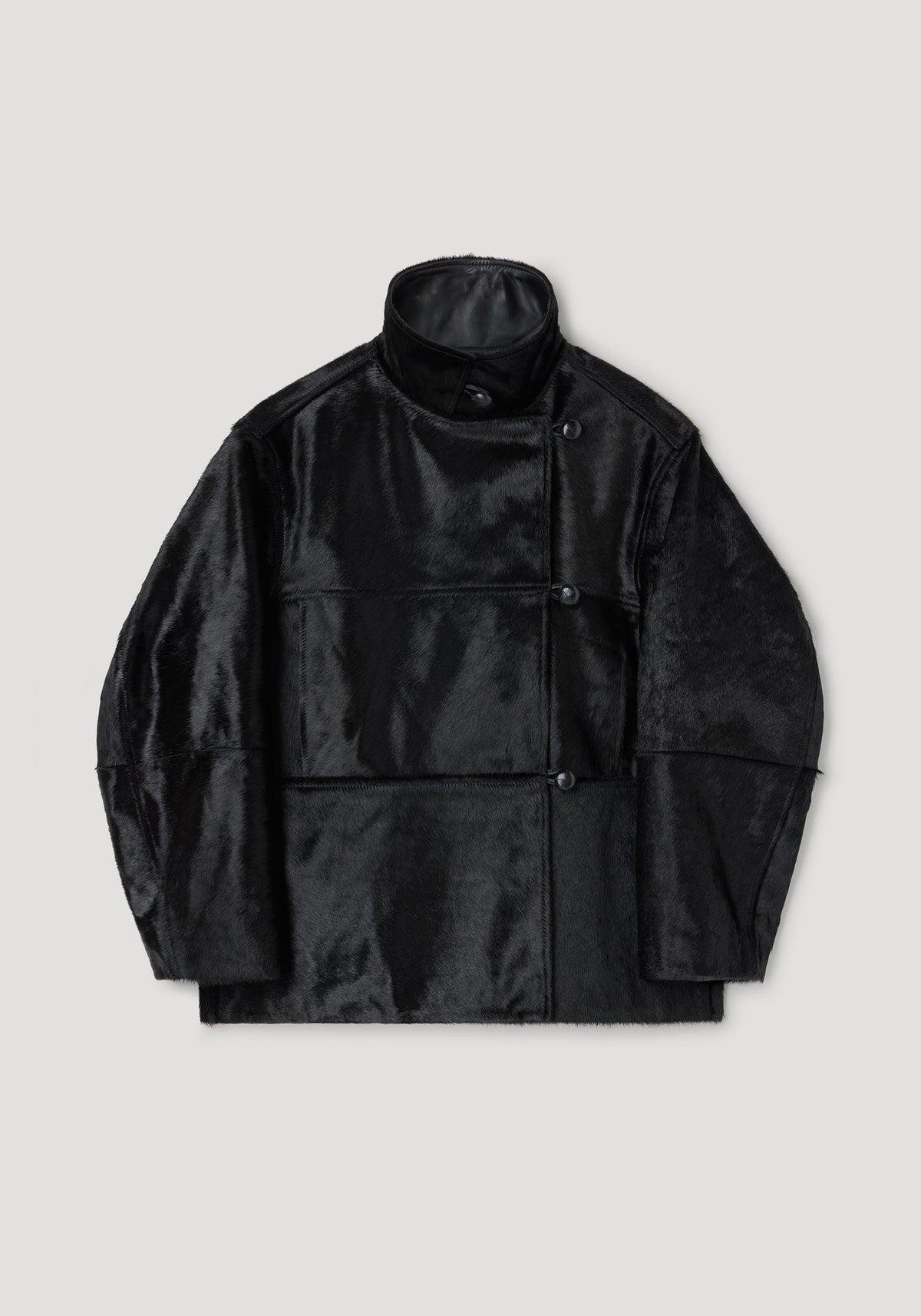 Black ponyhair jacket | black with a high collar, asymmetrical button closure, and a smooth, glossy finish providing a sleek and modern look.