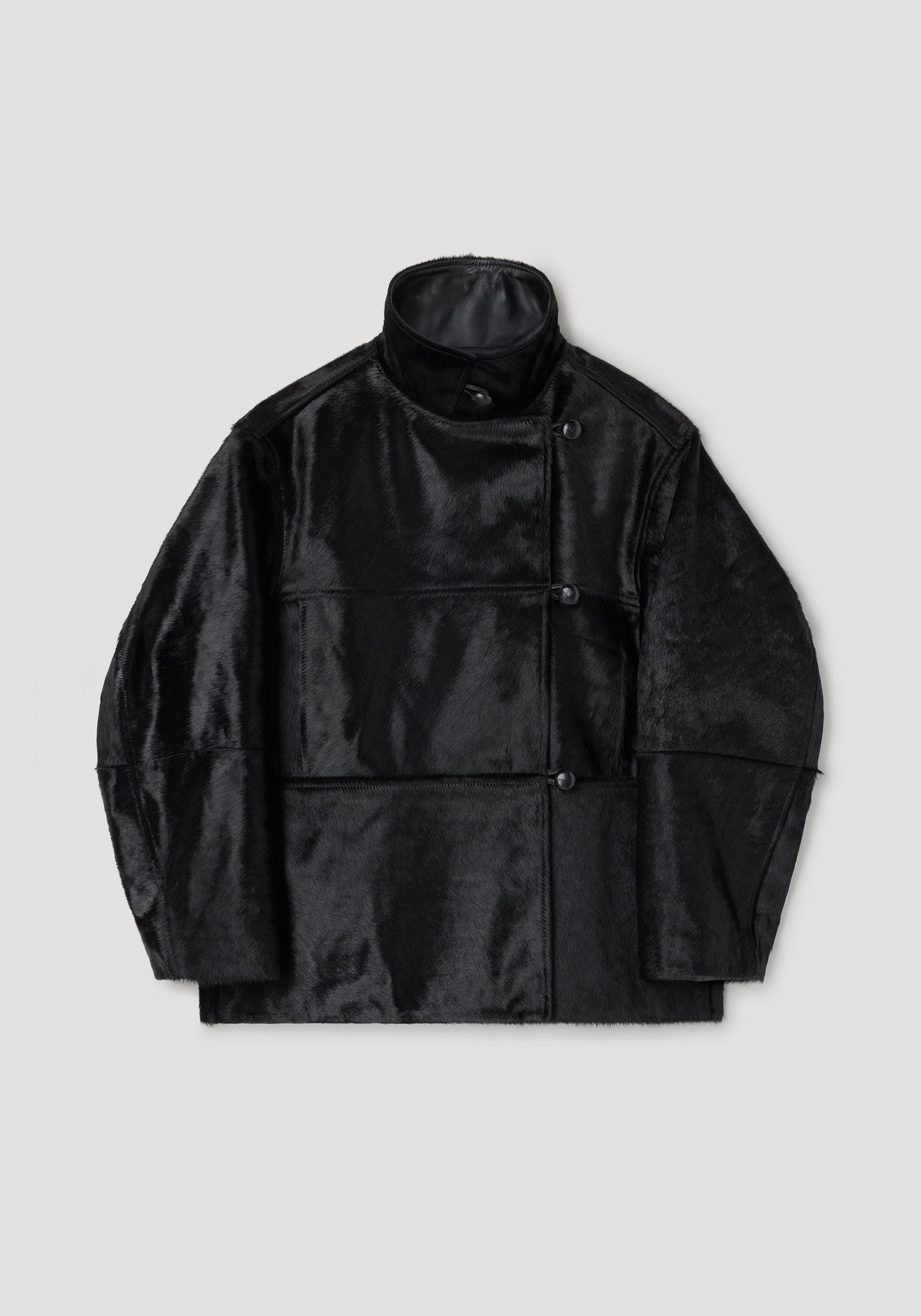 Black ponyhair jacket | black with a high collar, asymmetrical button closure, and a smooth, glossy finish providing a sleek and modern look.