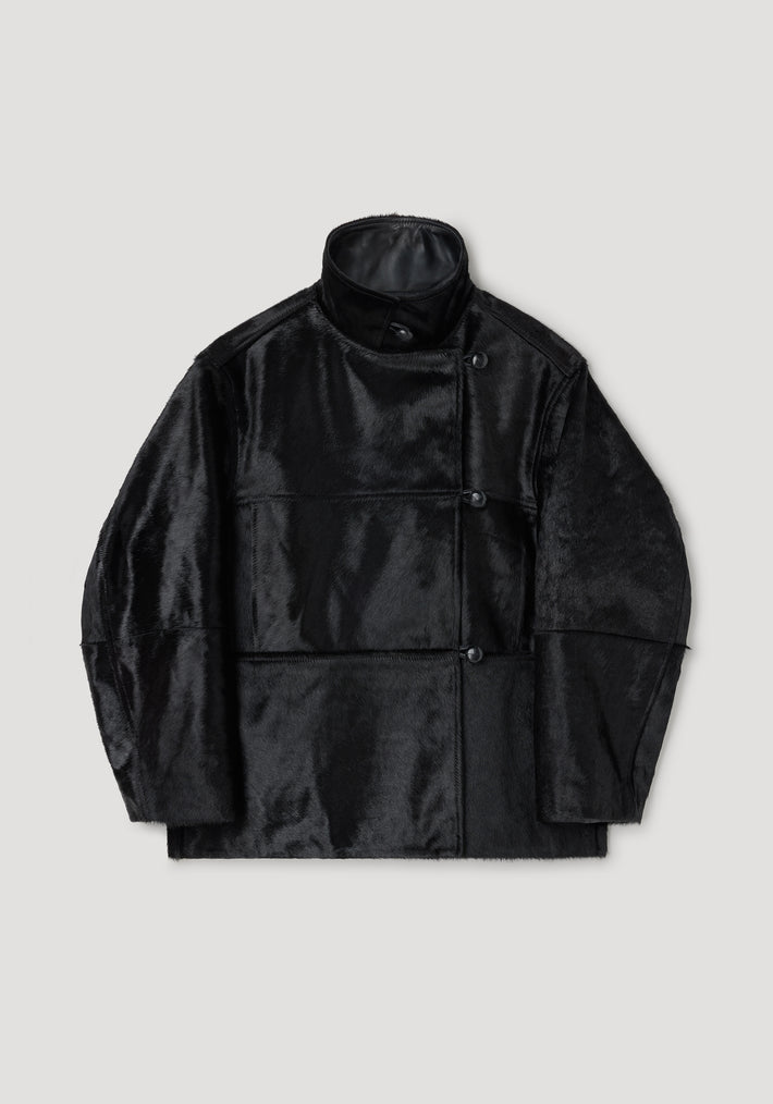 Black ponyhair jacket | black with a high collar, asymmetrical button closure, and a smooth, glossy finish providing a sleek and modern look.