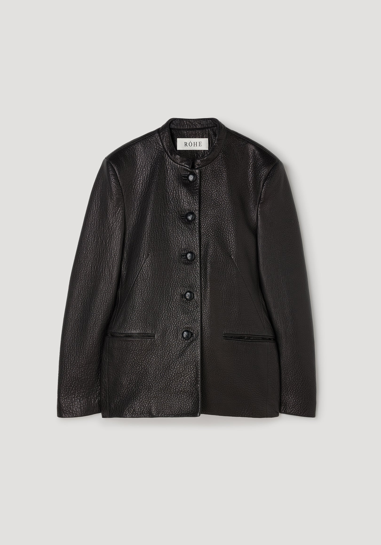 Shaped grain leather jacket | black with a textured finish, featuring a stand collar, five front buttons, and two side pockets, laid flat on a light background.