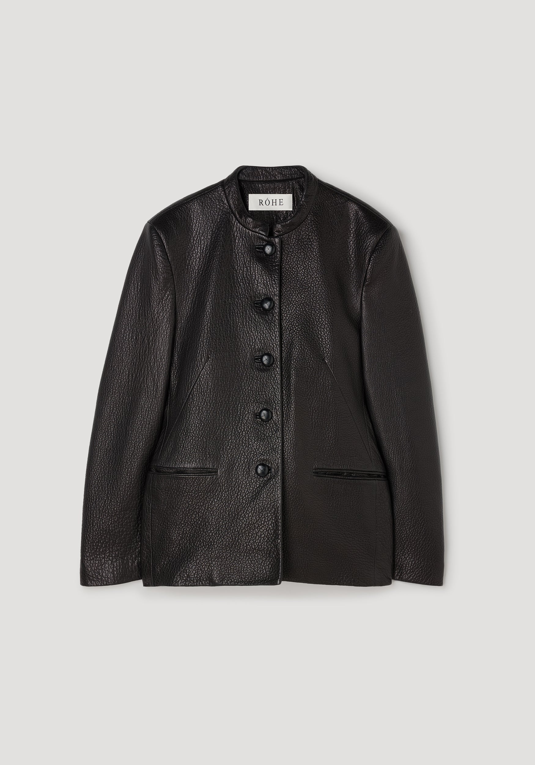 Shaped grain leather jacket | black with a textured finish, featuring a stand collar, five front buttons, and two side pockets, laid flat on a light background.