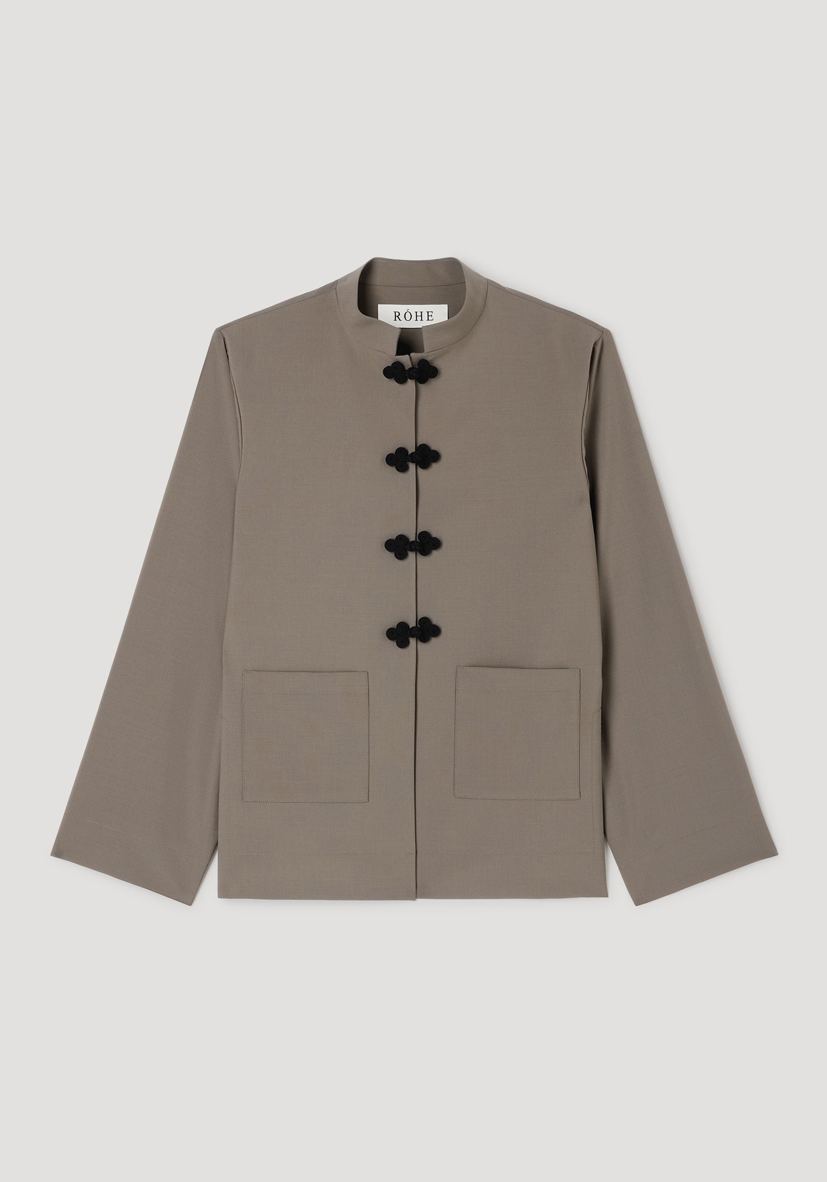 Pankou closure jacket | taupe featuring a minimalist design with a stand collar, black pankou frog closures, long sleeves, and two front patch pockets.
