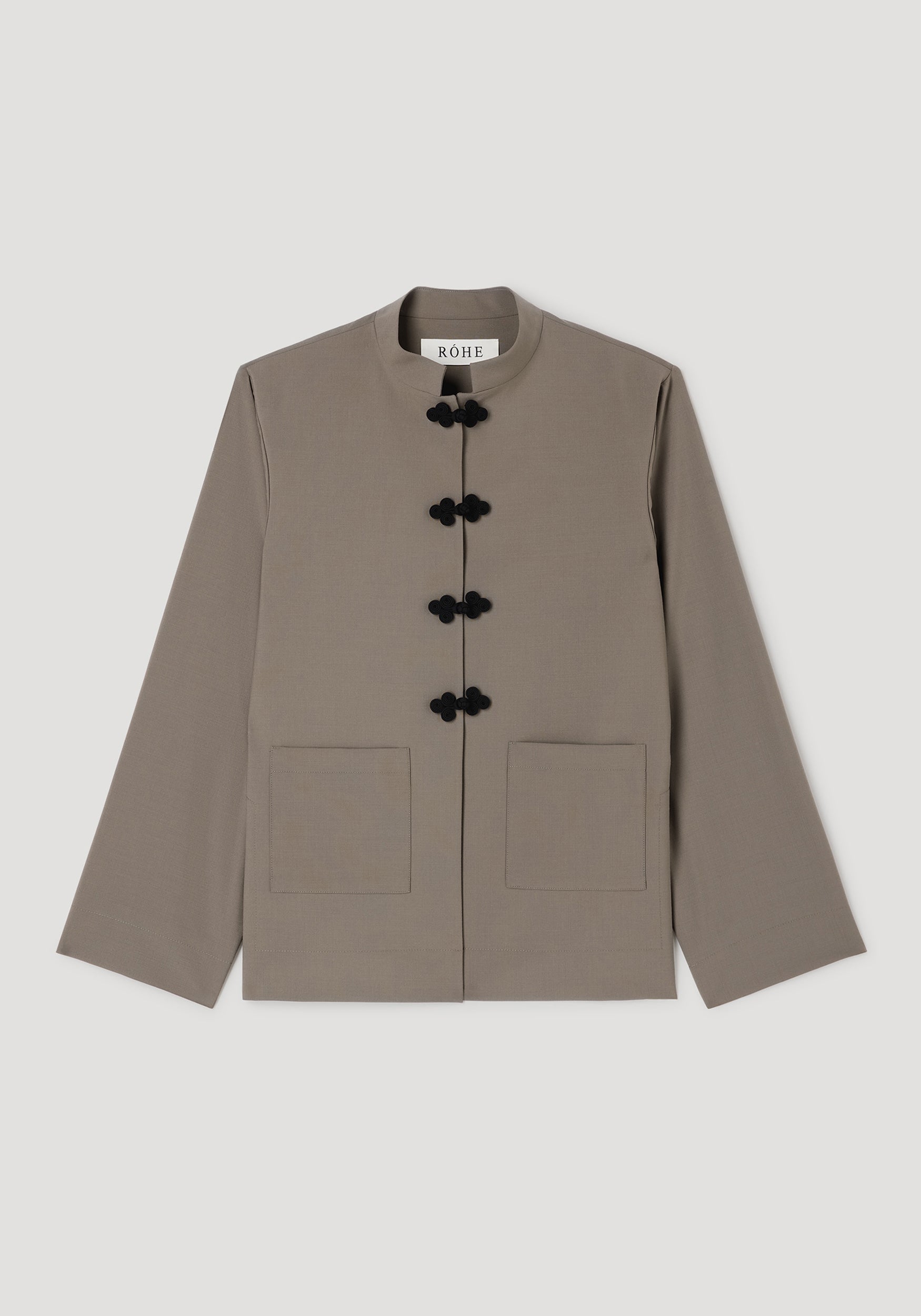 Pankou closure jacket | taupe featuring a minimalist design with a stand collar, black pankou frog closures, long sleeves, and two front patch pockets.