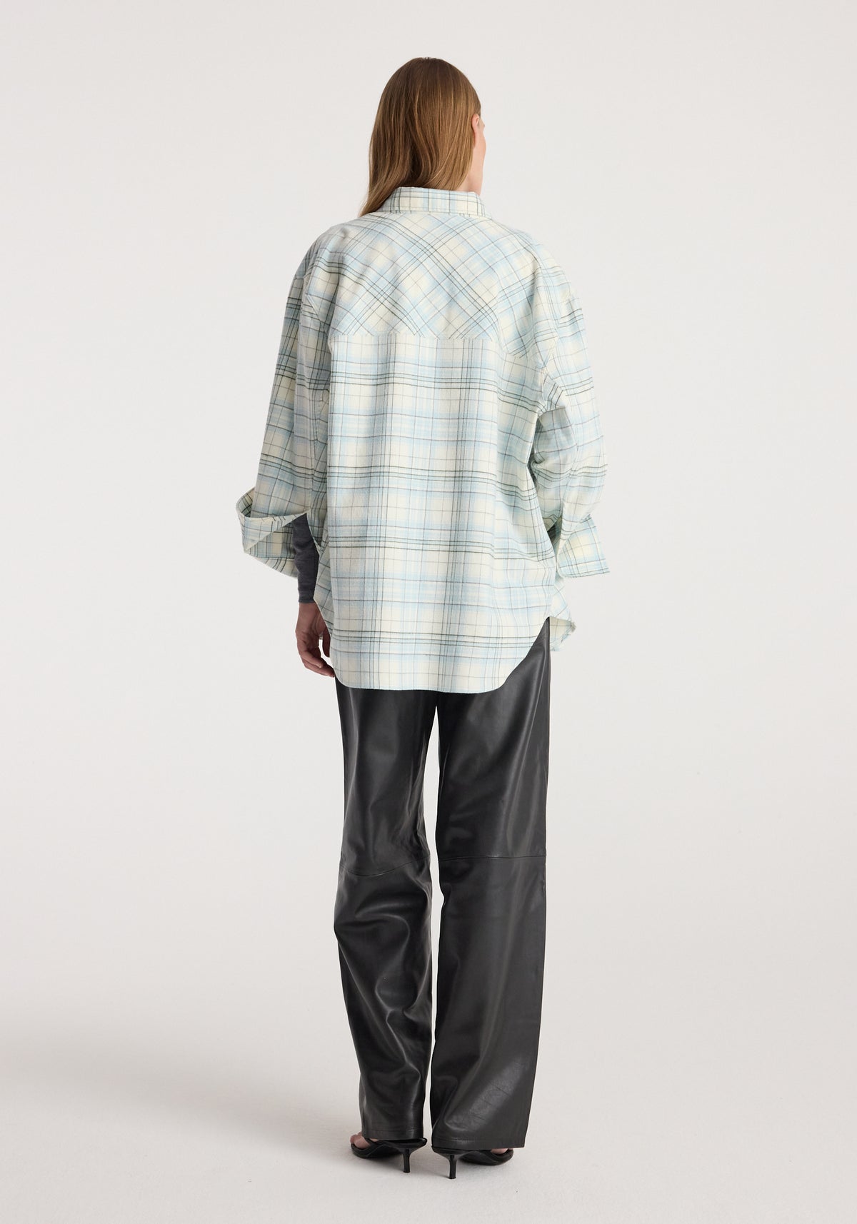 Flannel check overshirt | sea green check shown from the back on a model, styled with black trousers and a relaxed fit.