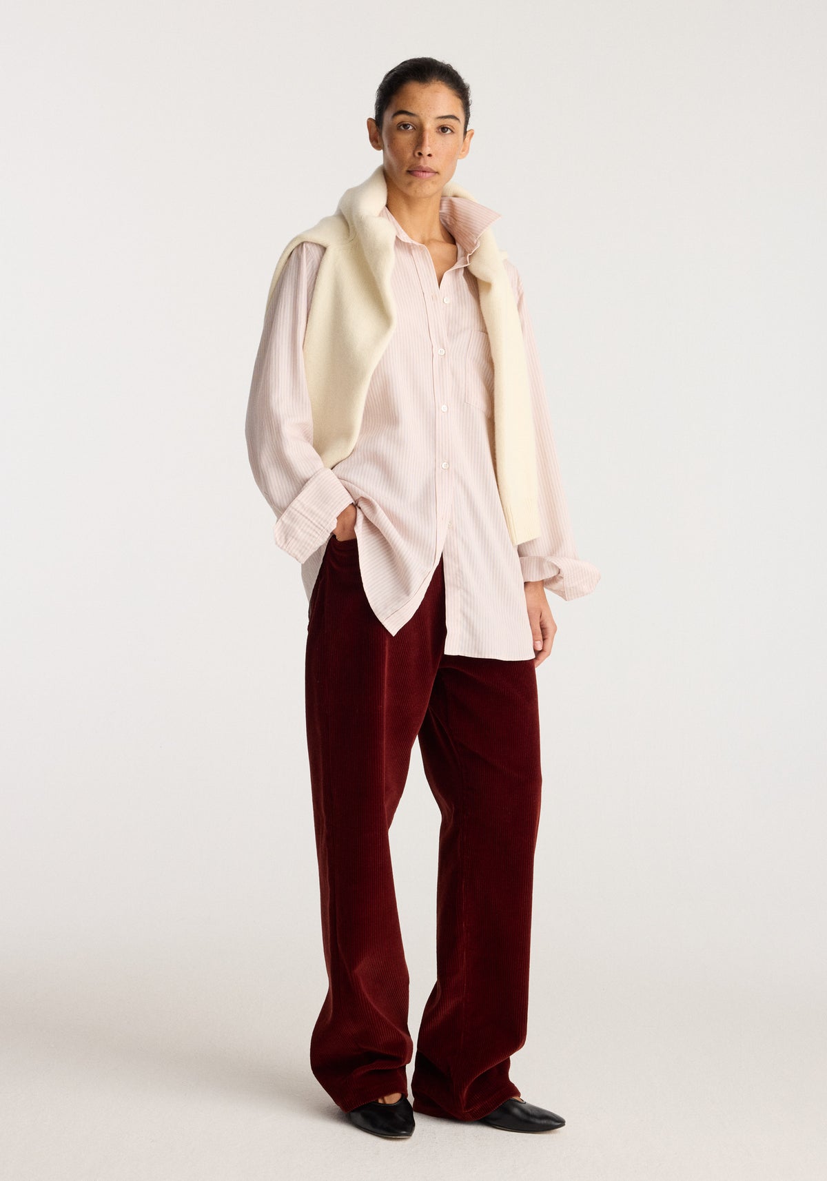 Classic fit striped shirt | rose stripe worn by a model with a cream vest, burgundy trousers, and black shoes against a neutral background