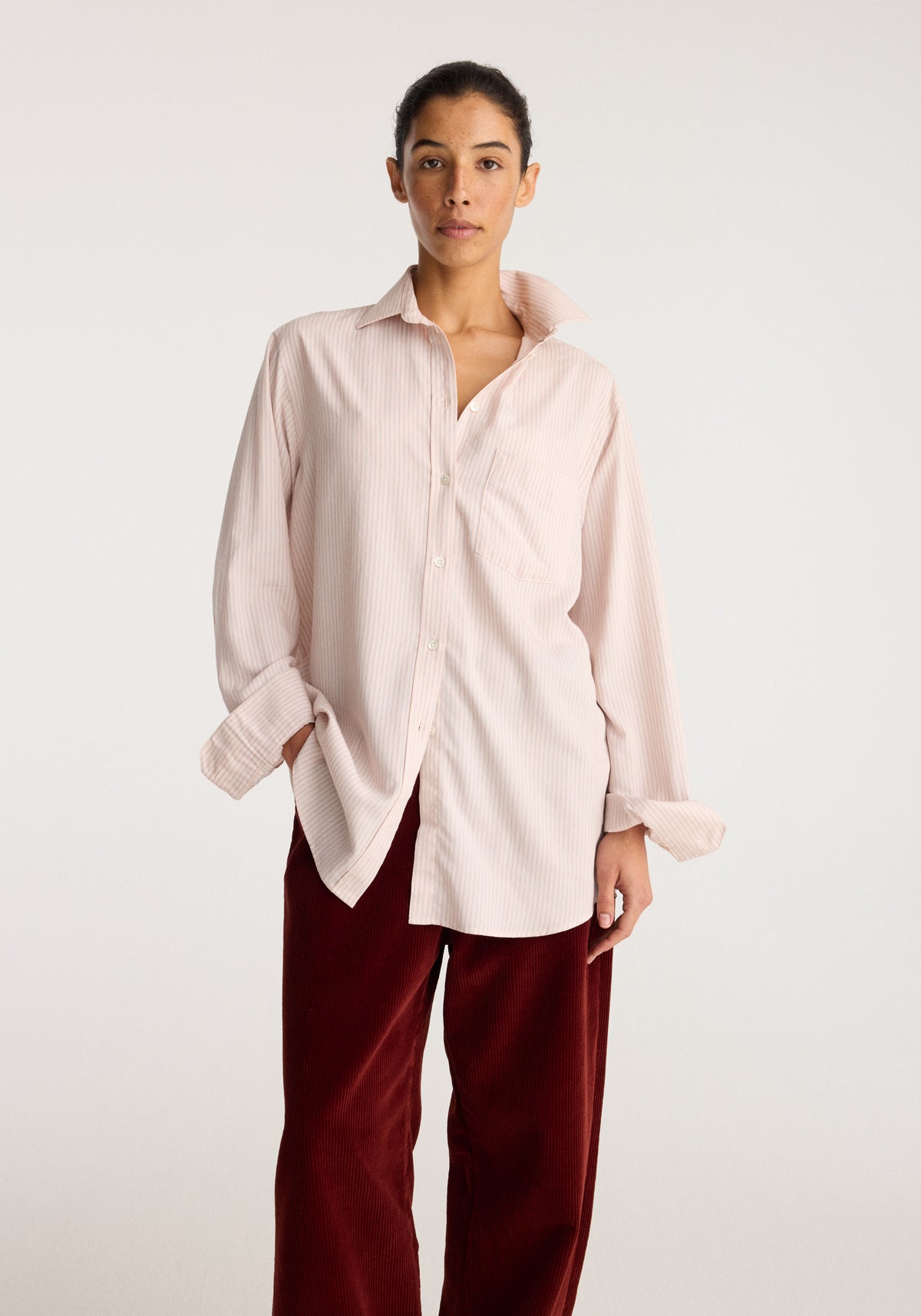Classic fit striped shirt | rose stripe worn by a model with pale pink stripes a button front pointed collar relaxed fit and long sleeves