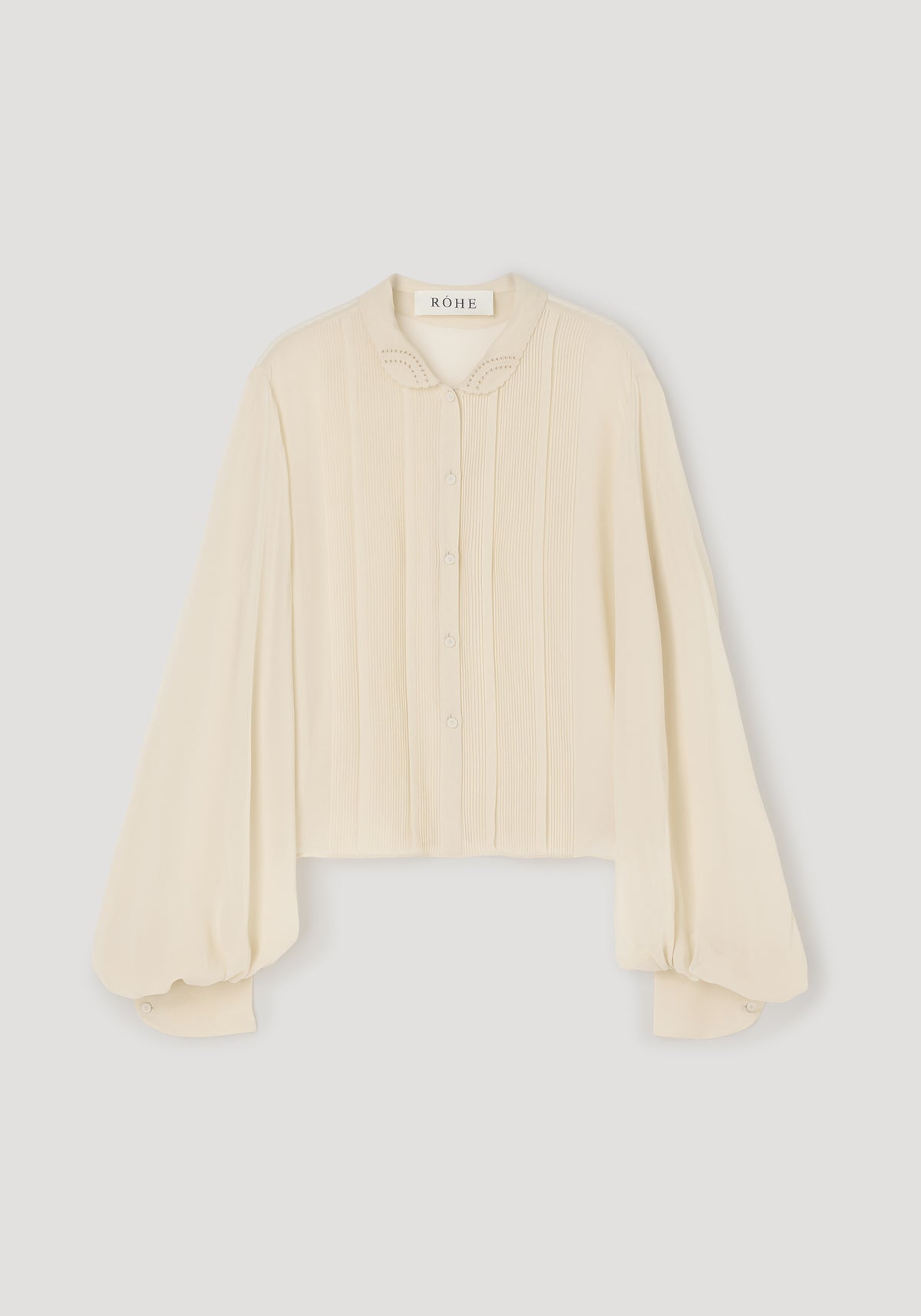 Romantic top | cream with long puffed sleeves, delicate button front, embroidered collar, and a soft, textured fabric ideal for elegant and feminine style.