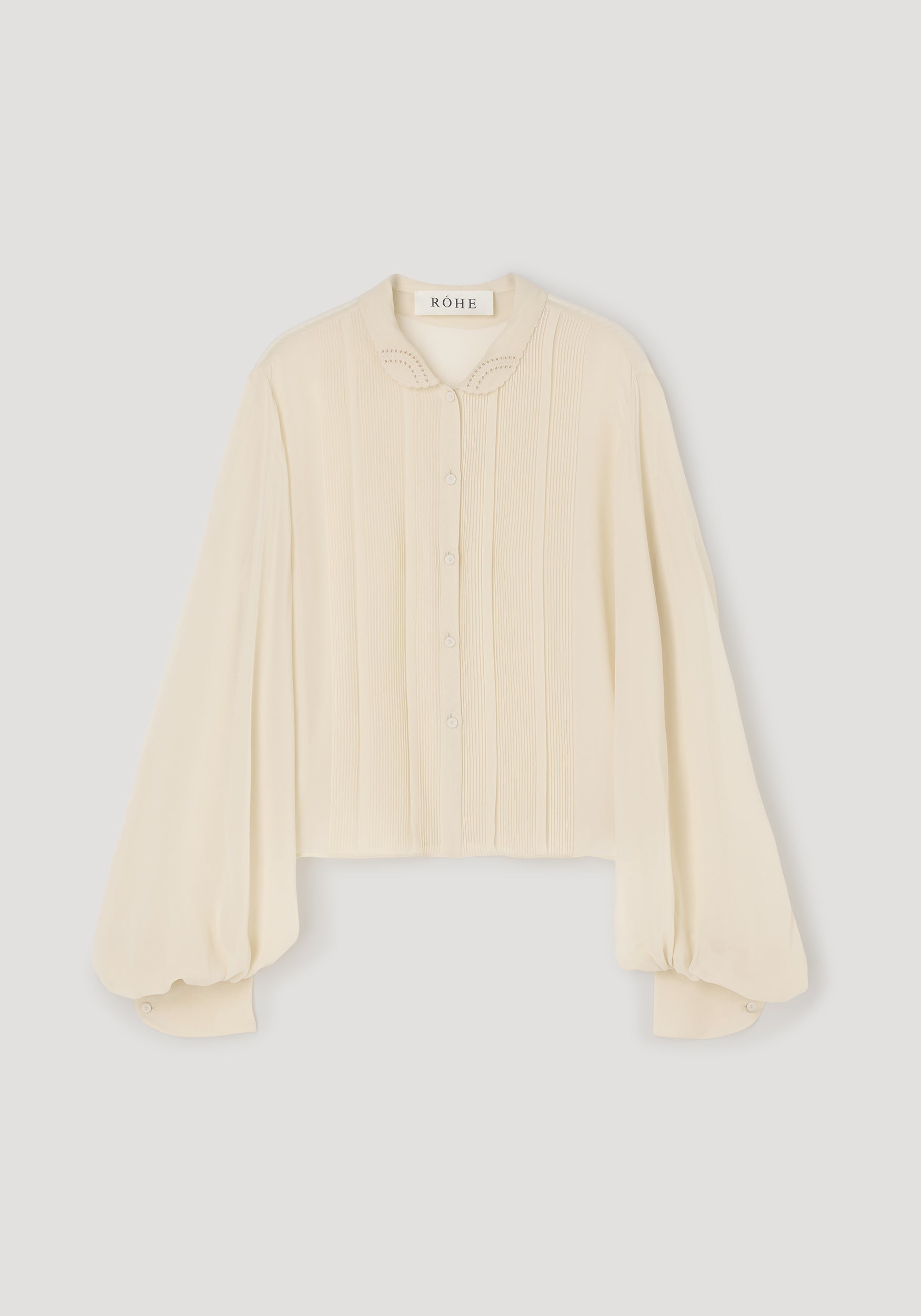 Romantic top | cream with long puffed sleeves, delicate button front, embroidered collar, and a soft, textured fabric ideal for elegant and feminine style.