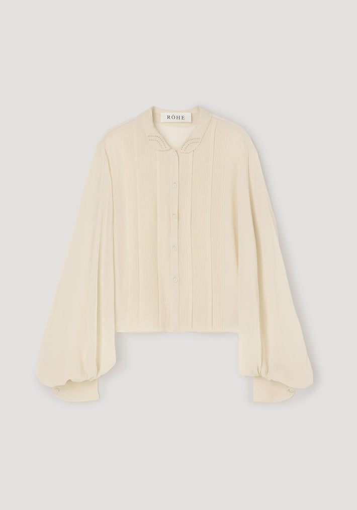 Romantic top | cream with long puffed sleeves, delicate button front, embroidered collar, and a soft, textured fabric ideal for elegant and feminine style.