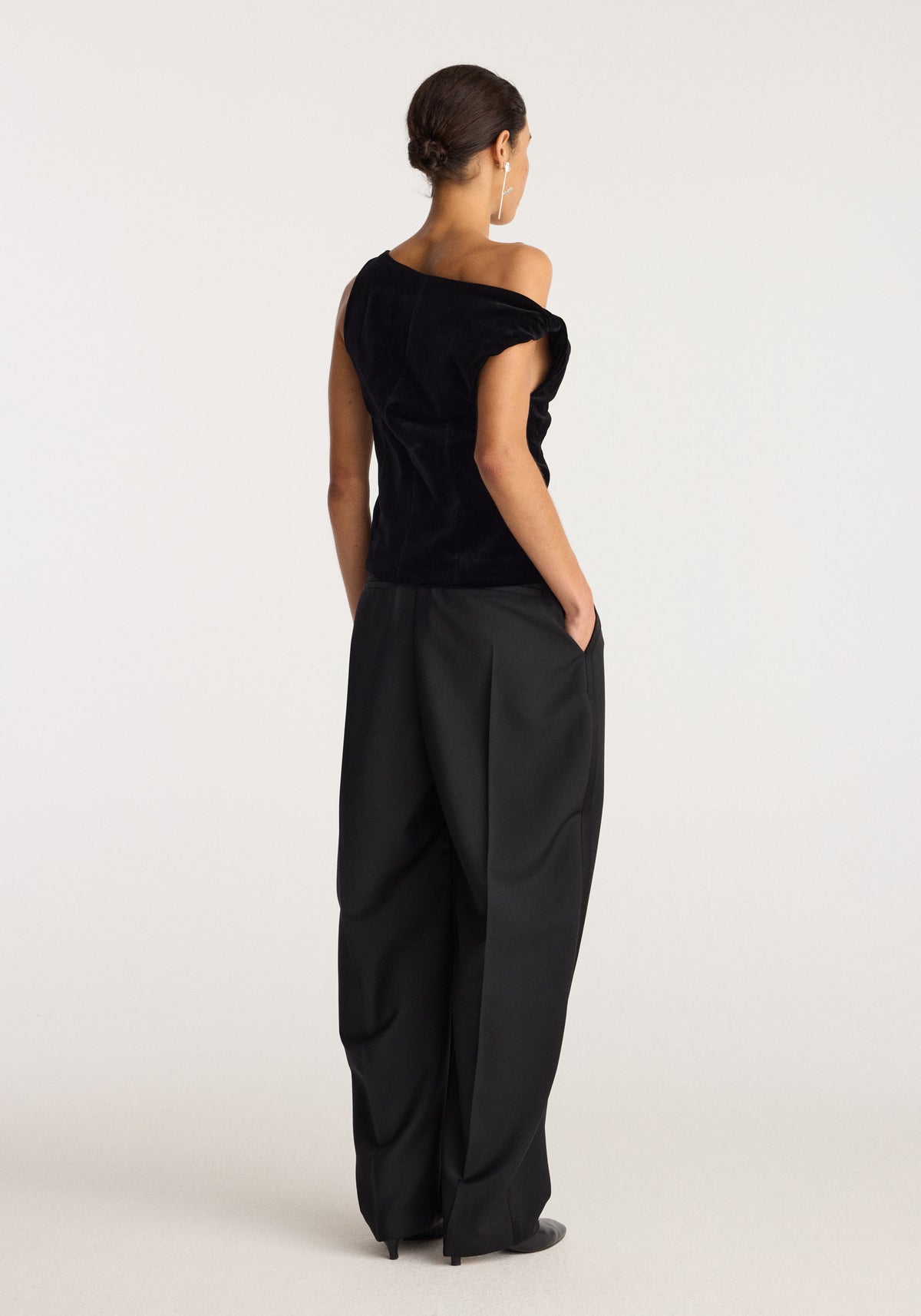Draped velvet top | black shown from the back on a model with an off shoulder neckline, short sleeves, and softly gathered draping.