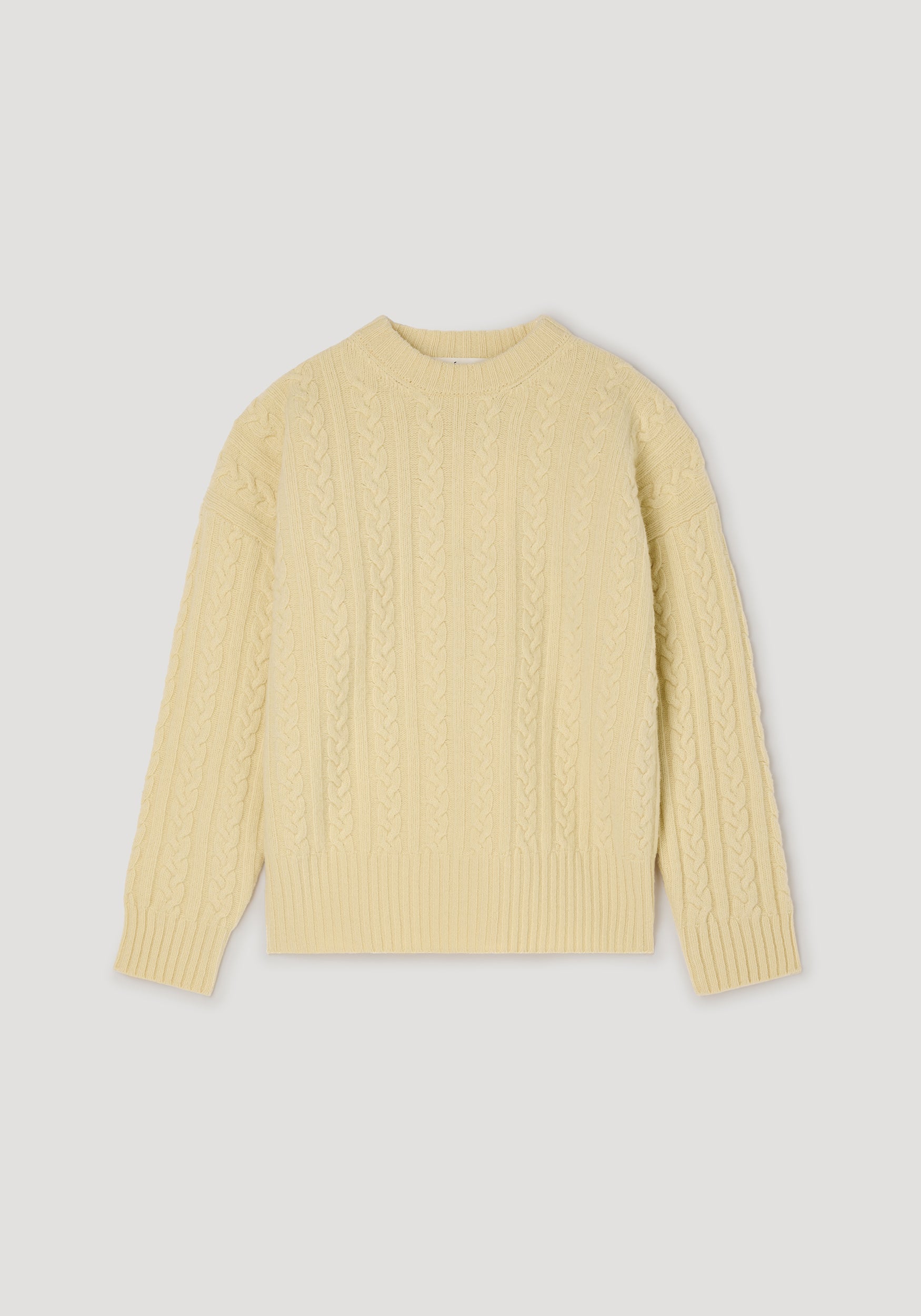 Cable knit jumper | butter in a soft yellow shade, featuring a classic crew neck, long sleeves, and intricate cable knit pattern throughout for a cozy, stylish look.