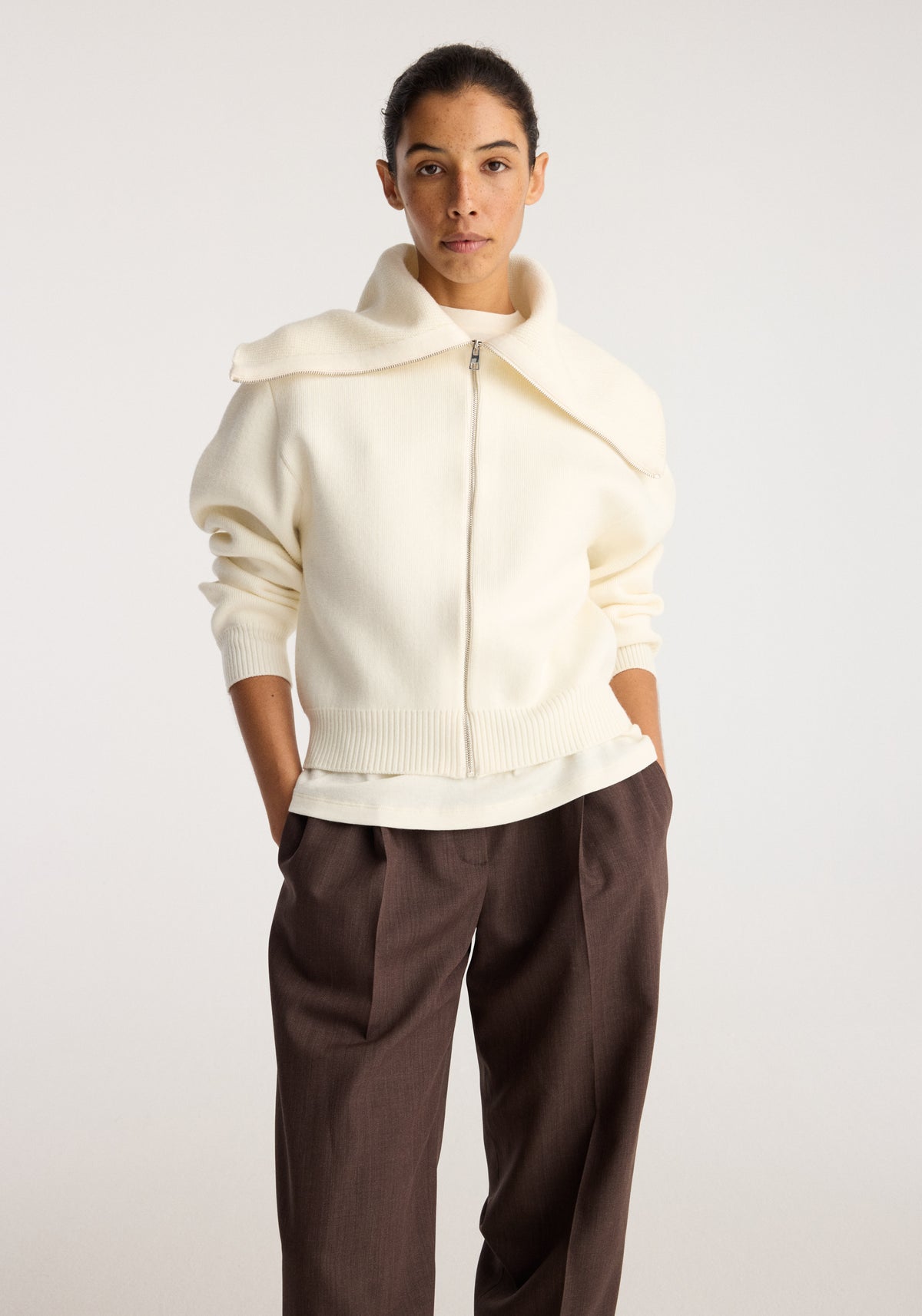 Reversible sailor zip cardigan | cream with oversized collar and front zip, styled on a model with brown trousers against a neutral background