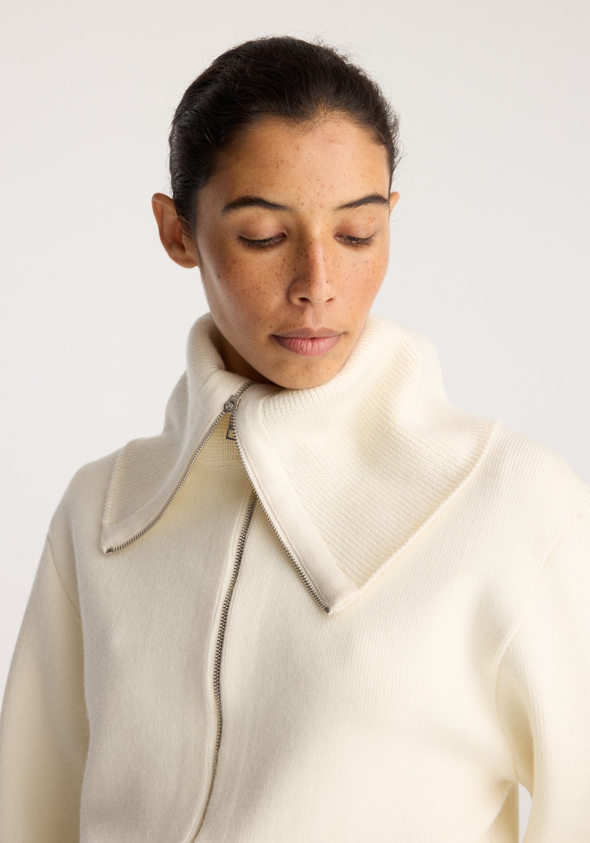 Reversible sailor zip cardigan | cream with a high sailor collar and front zip modeled in a studio portrait