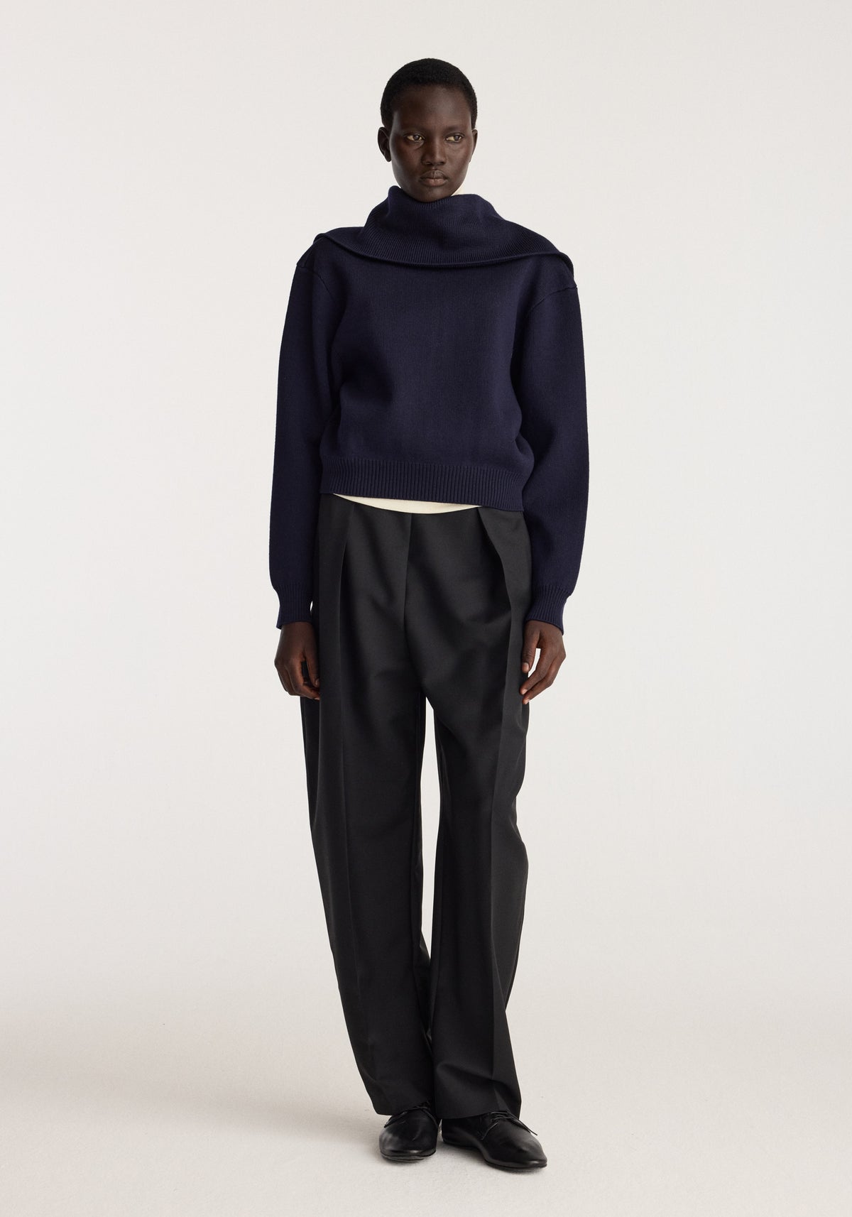 Reversible sailor zip cardigan | navy shown on a model with a high neckline and relaxed fit styled with black trousers and black shoes