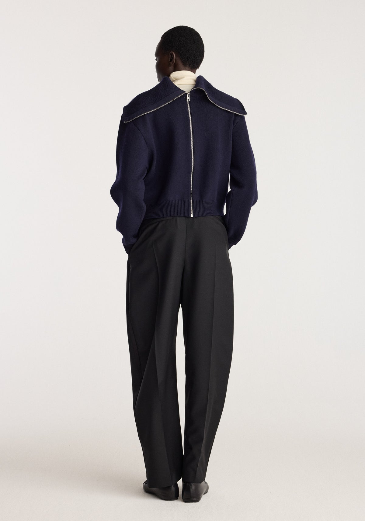 Reversible sailor zip cardigan | navy shown from the back on a model with a sailor collar and long sleeves worn with tailored black trousers